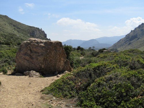 View back on the way to Cala Bóquer with a big stone